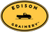 Edison Grainery Logo - a stamped image of a vintage black truck centered on a golden yellow oval, framed above and below by the words EDISON GRAINERY TM
