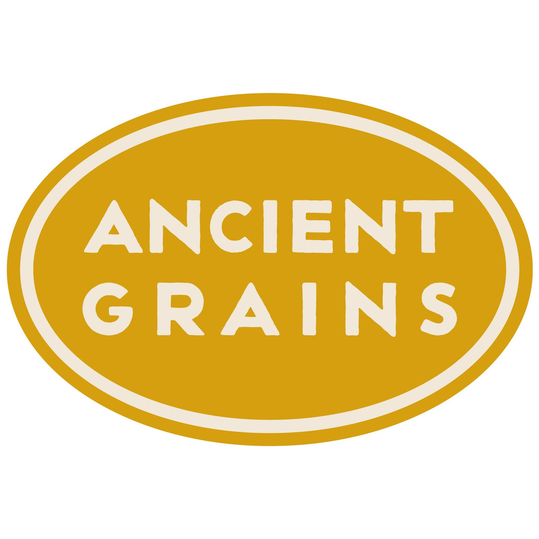 A golden-yellow oval with a cream inlayed border containing the phrase "ANCIENT GRAINS" in block letters.
