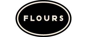 Flours category logo: The word FLOURS, centered in a black oval with a thin, inset cream colored border.